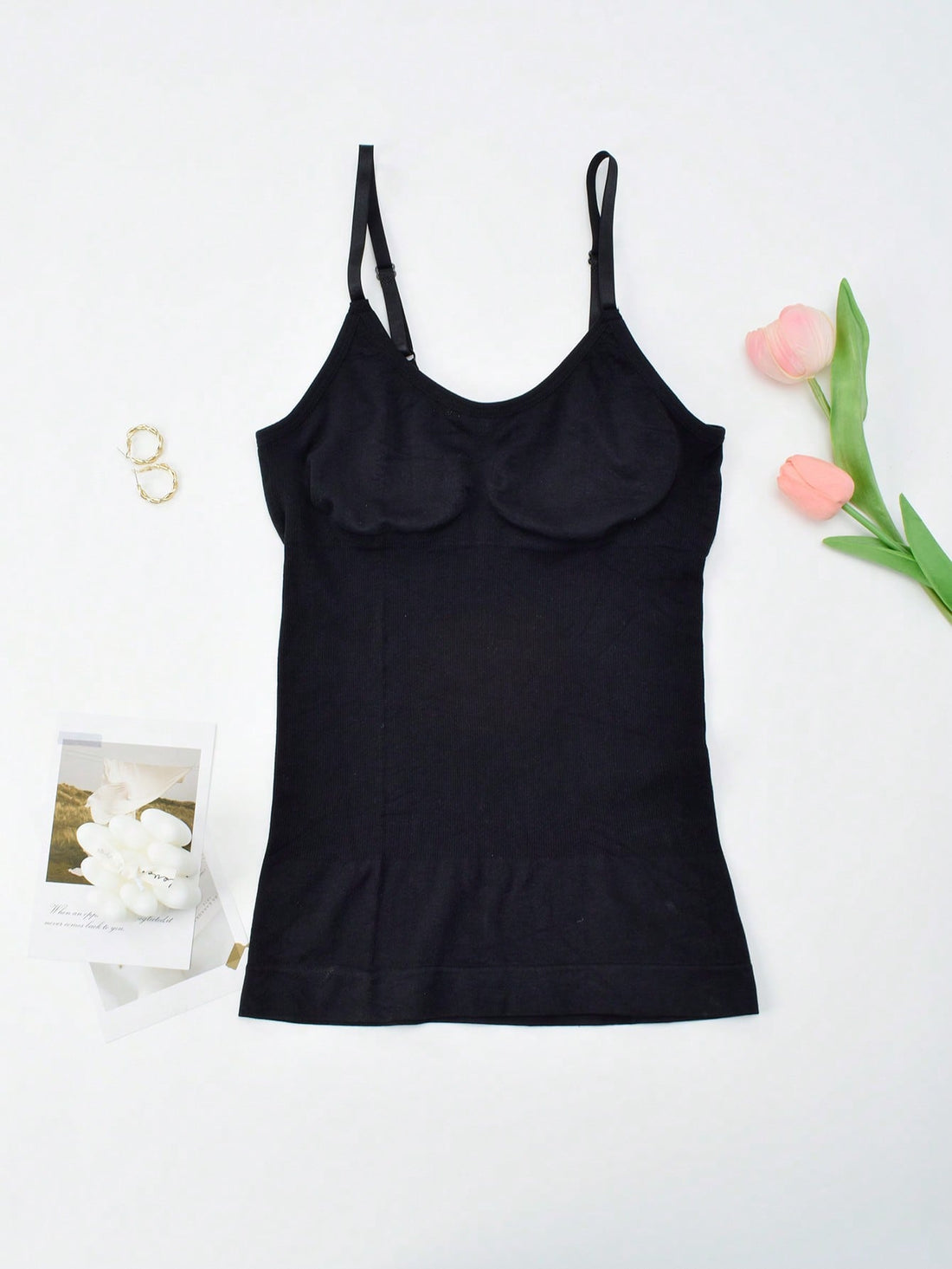 Black seamless shapewear camisole featuring targeted waist control, backless design, adjustable straps, and unlined wireless support for women.