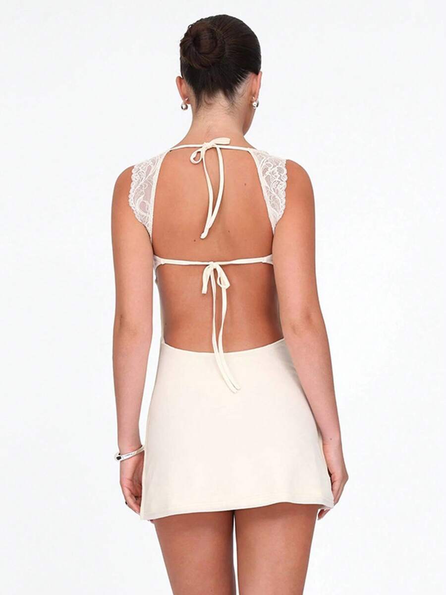Women's sleeveless white lace-trimmed bustier mini dress featuring backless tie-up detail and slim fit A-line silhouette.