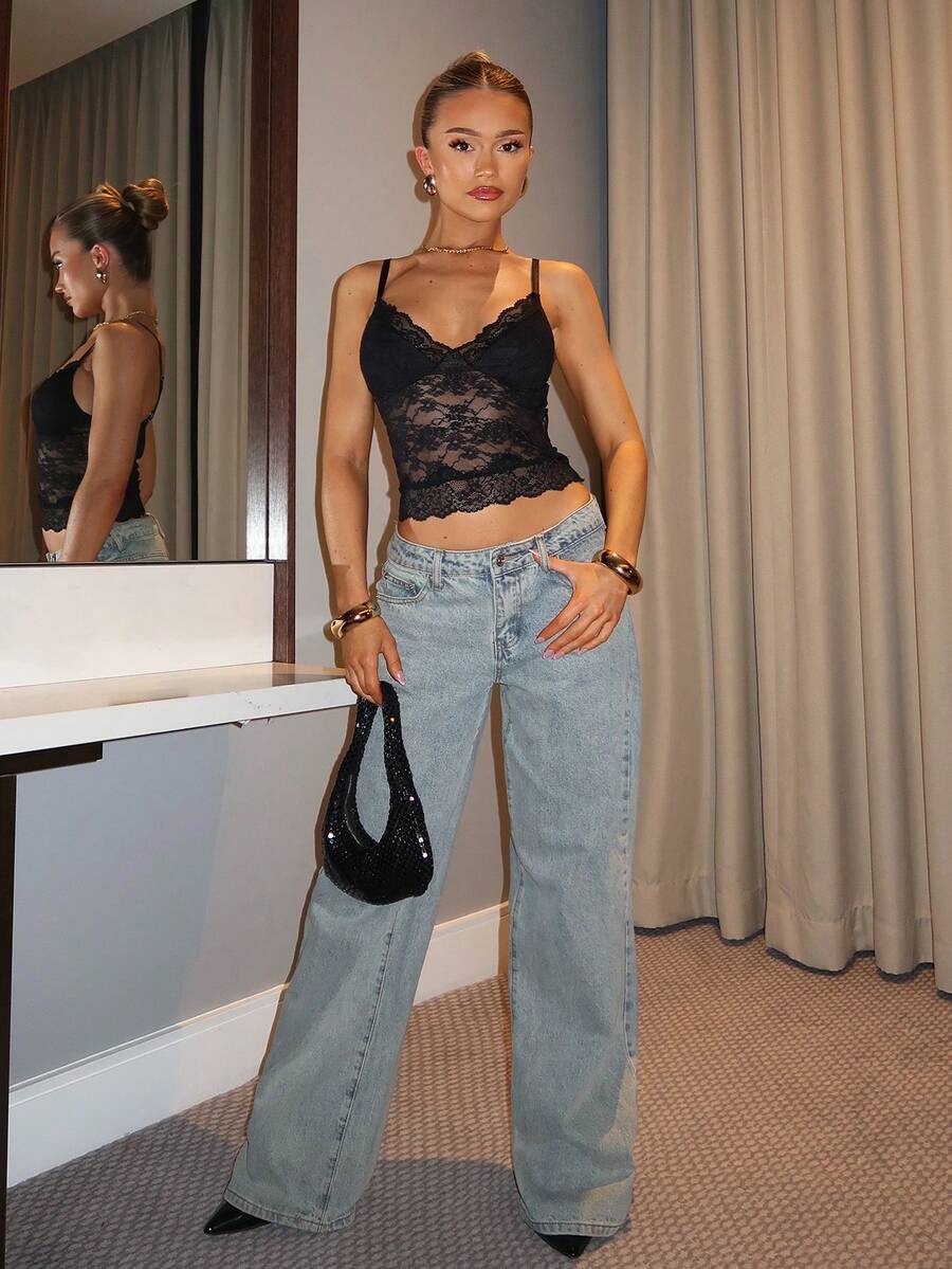 Black floral lace cropped camisole top for women featuring delicate spaghetti straps, cup detail, and semi-sheer contrast lace.