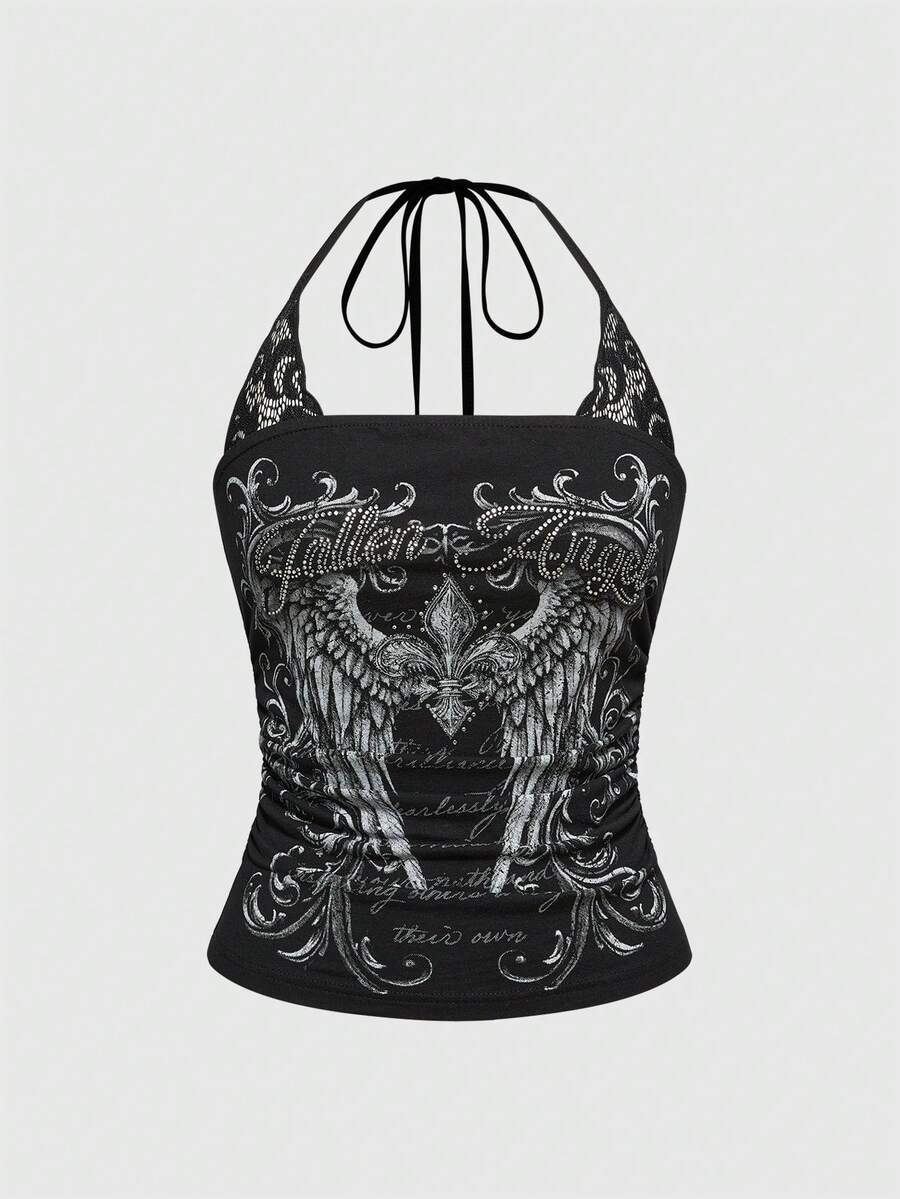 Woman wearing a black Y2K concert print 2-in-1 contrast lace halter crop top featuring a backless design with knot details.