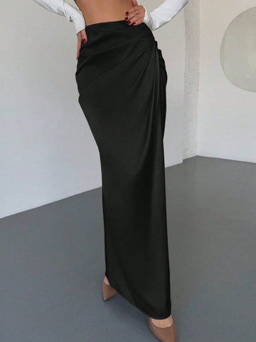 Women's solid color ruched satin maxi skirt featuring an asymmetrical wrap design and side slit.