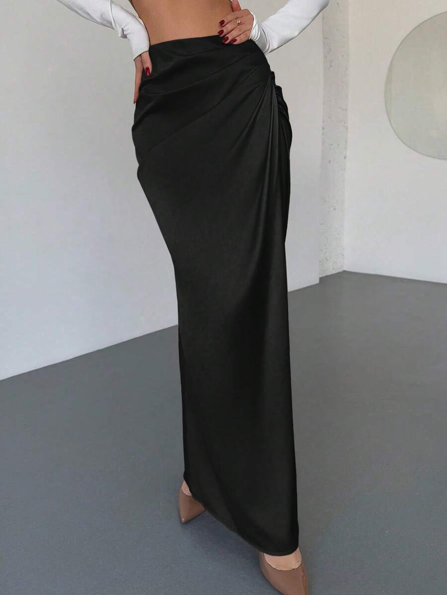 Women's solid color ruched satin maxi skirt featuring an asymmetrical wrap design and side slit.