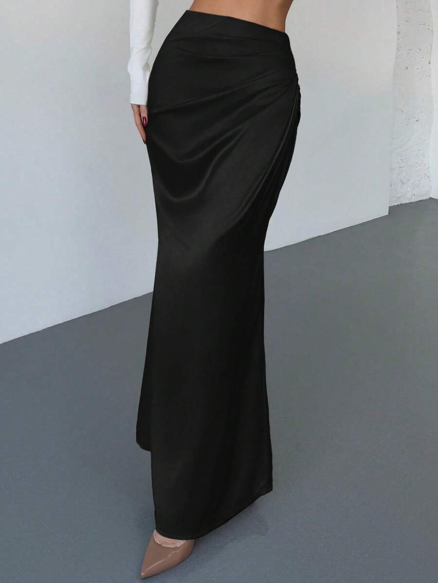 Women's solid color ruched satin maxi skirt featuring an asymmetrical wrap design and side slit.
