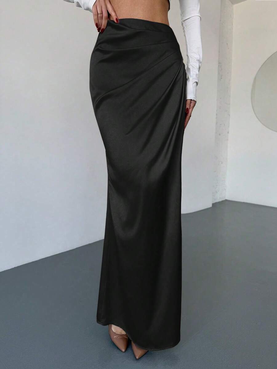 Women's solid color ruched satin maxi skirt featuring an asymmetrical wrap design and side slit.