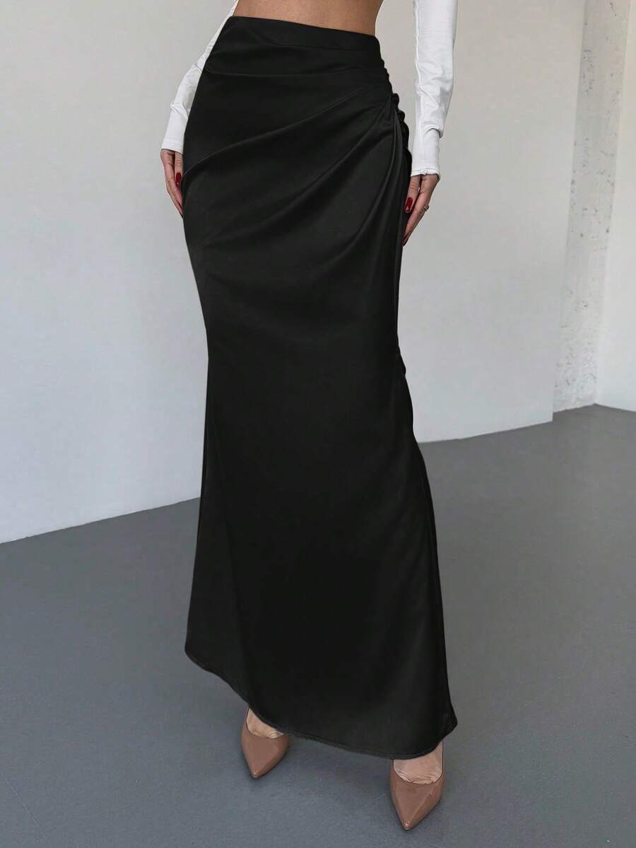 Women's solid color ruched satin maxi skirt featuring an asymmetrical wrap design and side slit.
