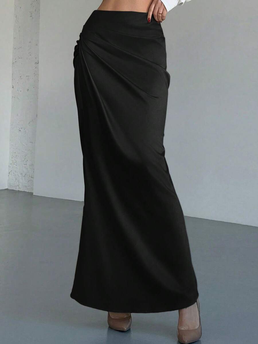 Women's solid color ruched satin maxi skirt featuring an asymmetrical wrap design and side slit.