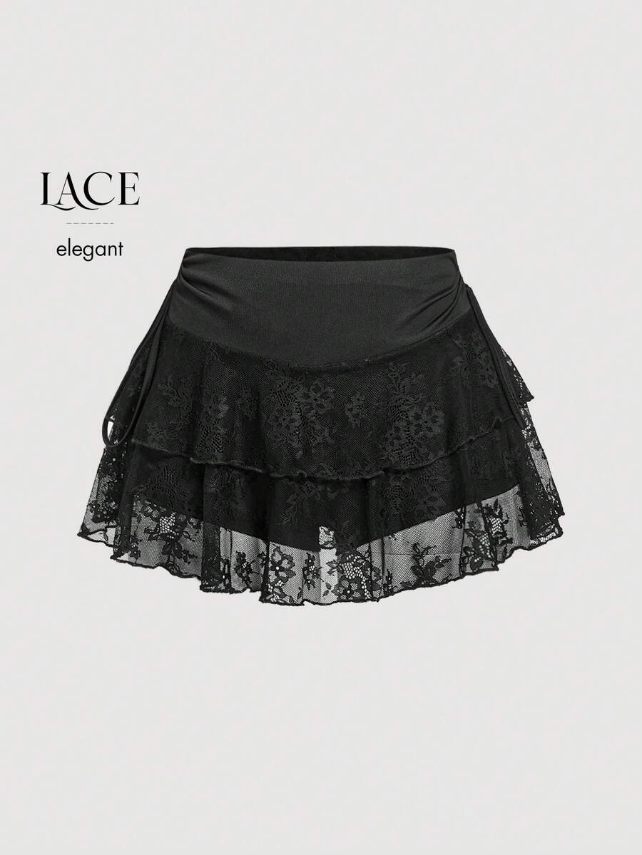 A woman wearing a black lace tiered ruffle mini skirt skort featuring a mid-waist design and layered hemline.