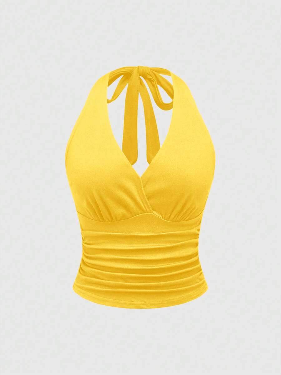 Women's halter crop tank top featuring a backless silhouette and ruched detailing in a slim fit design.