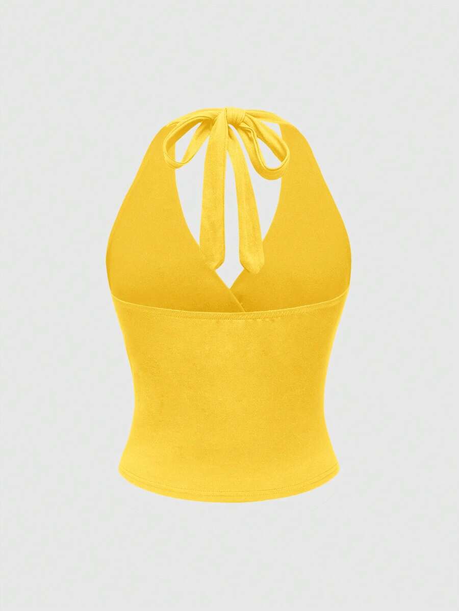 Women's halter crop tank top featuring a backless silhouette and ruched detailing in a slim fit design.