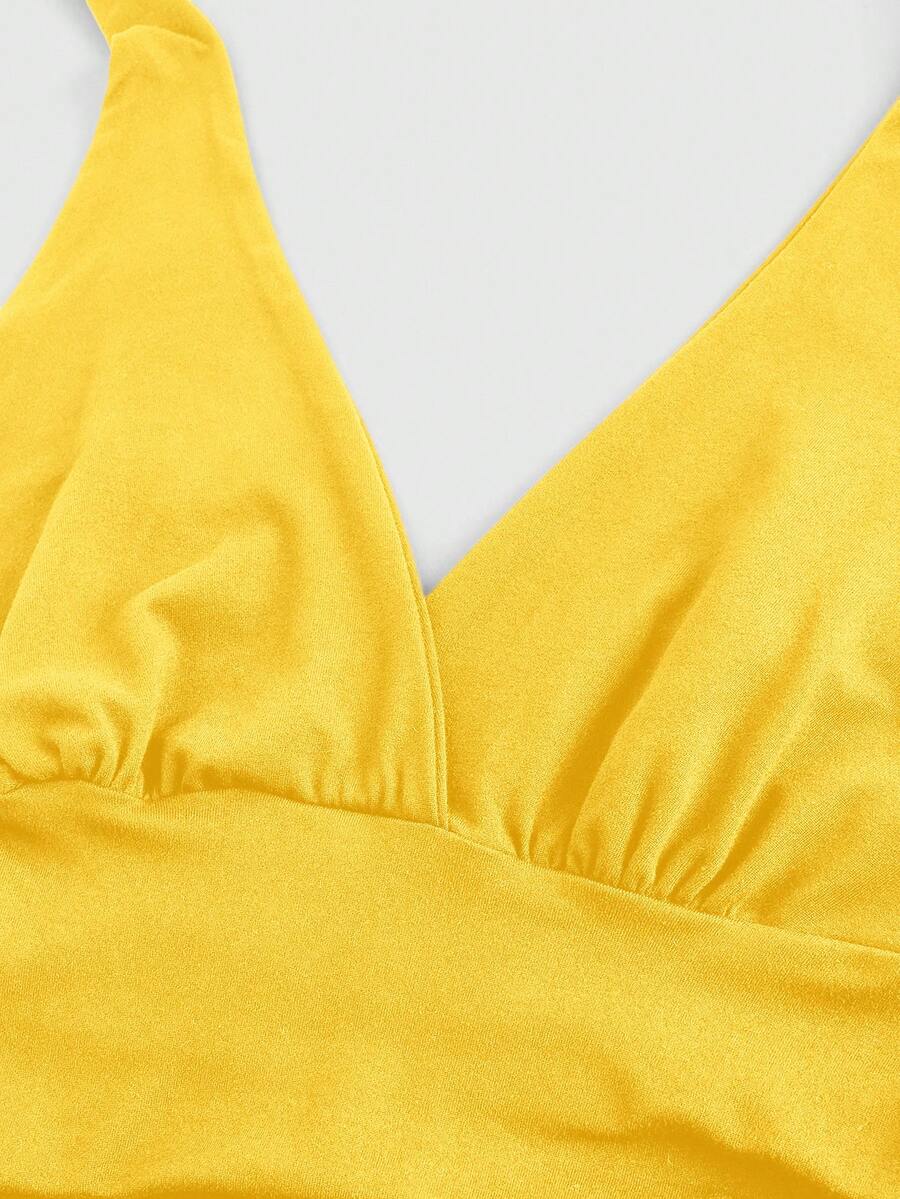Women's halter crop tank top featuring a backless silhouette and ruched detailing in a slim fit design.