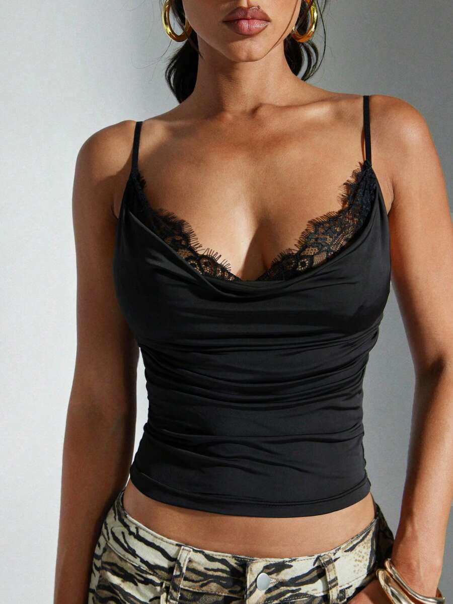 Women's solid color draped neck cami top featuring contrast lace trim, backless design, and delicate spaghetti straps in a slim fit style.