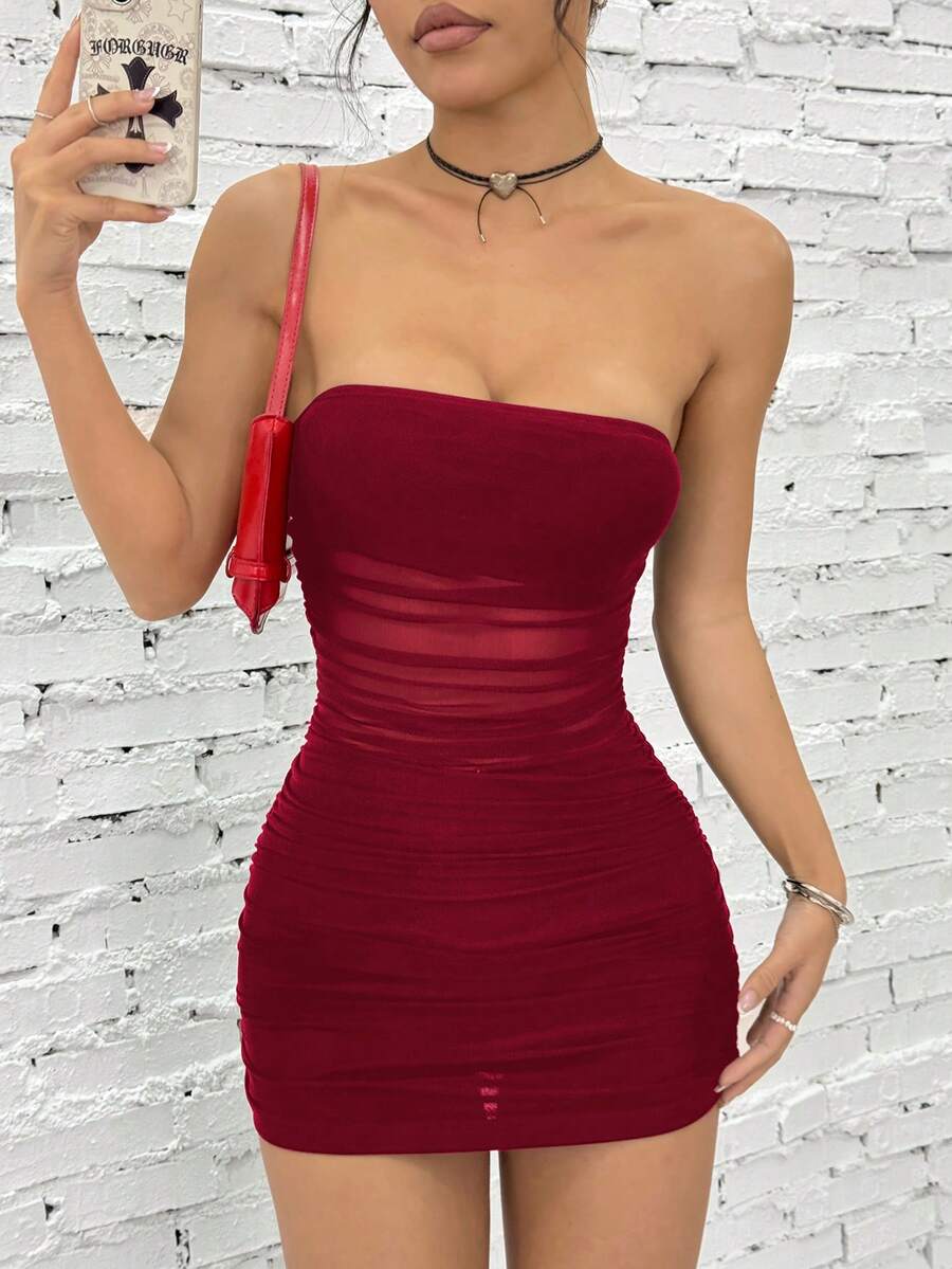 Women's blue strapless ruched mesh bodycon mini dress with backless design and slim fit for a night out.