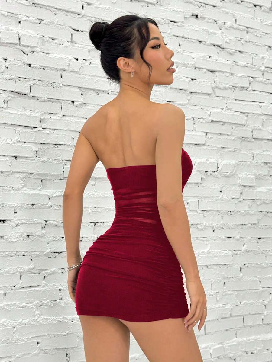 Women's blue strapless ruched mesh bodycon mini dress with backless design and slim fit for a night out.