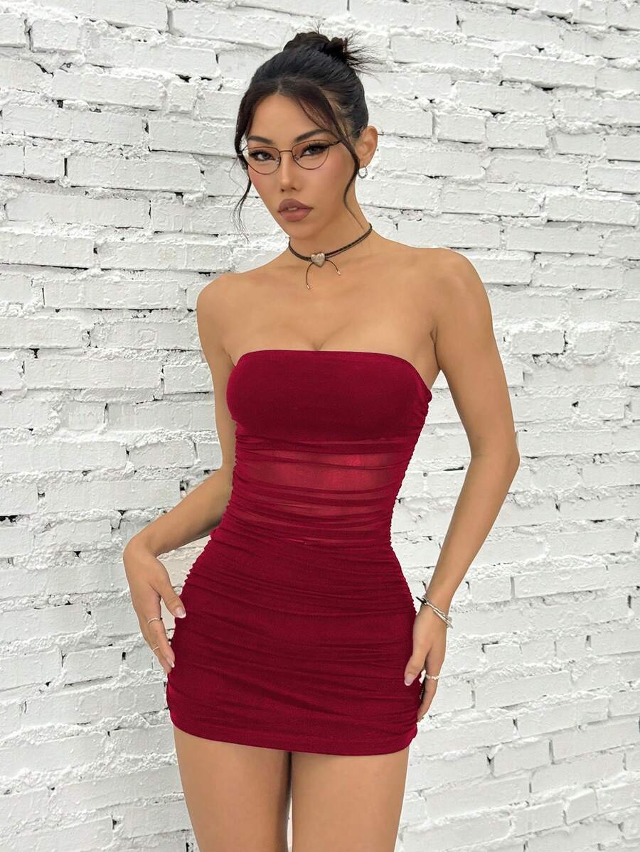 Women's blue strapless ruched mesh bodycon mini dress with backless design and slim fit for a night out.