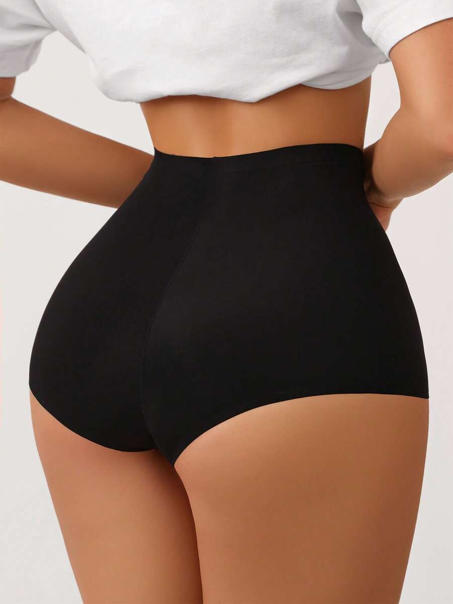 Women's black high stretch shapewear shorts with a mid waist fit and semi-sheer fabric.
