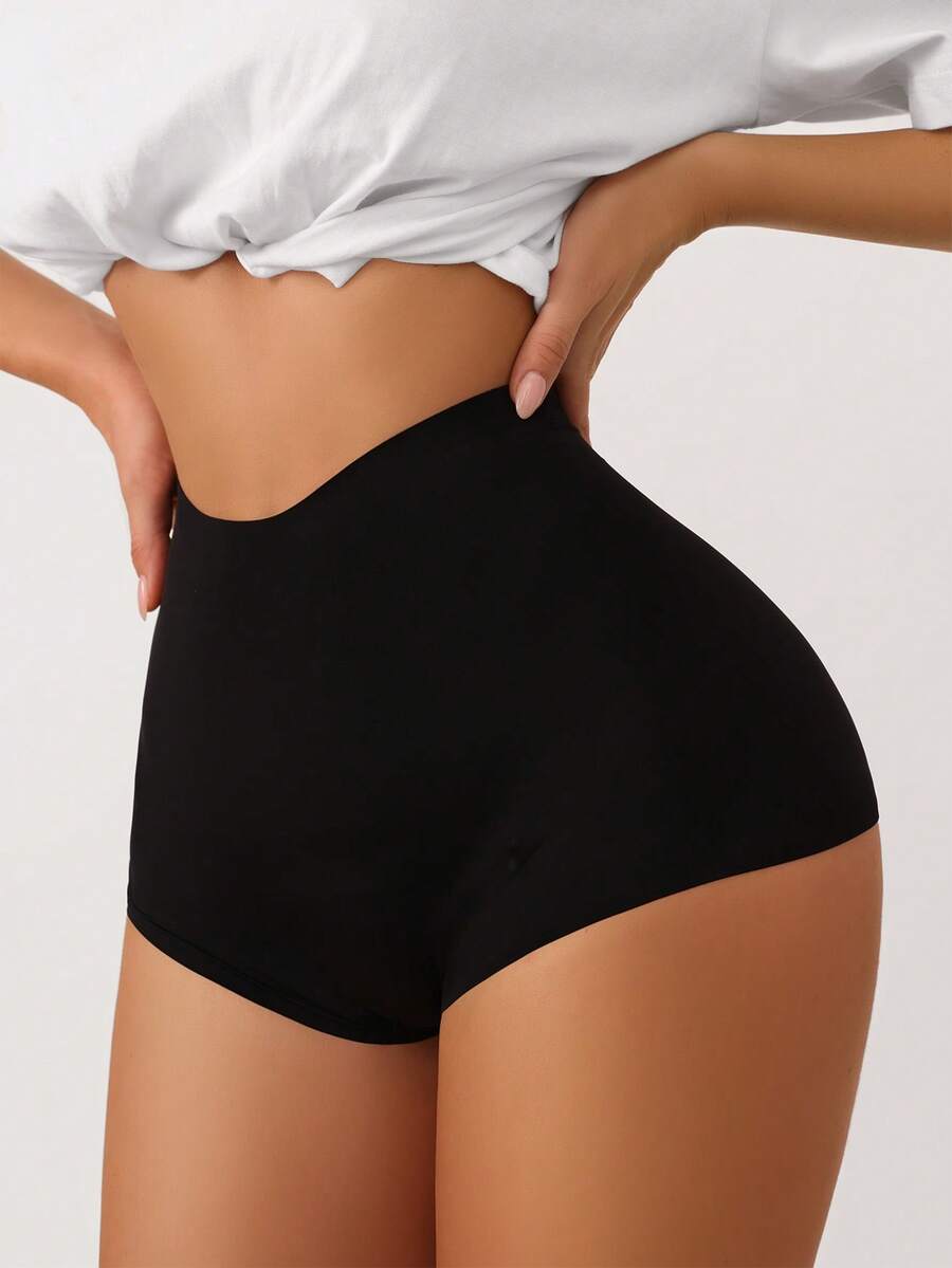 Women's black high stretch shapewear shorts with a mid waist fit and semi-sheer fabric.