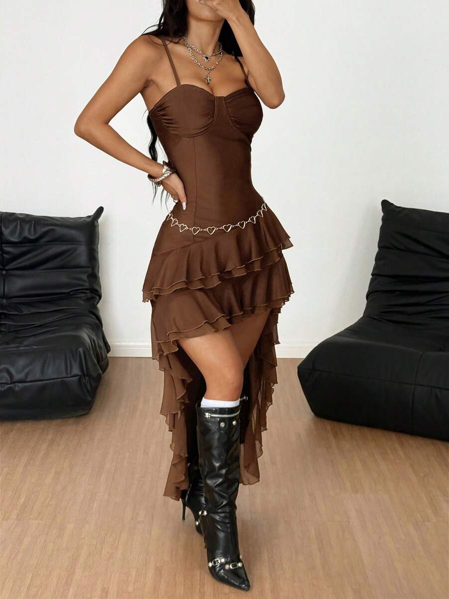 Front view of a woman wearing a sleeveless black slim fit cami maxi dress with spaghetti straps and an asymmetrical tiered ruffle hem.