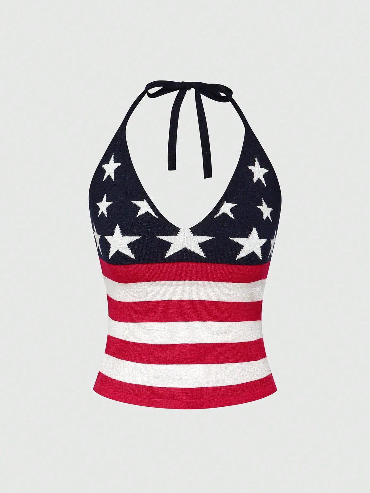 An apricot backless halter knit crop top featuring an American flag print, tied with a back knot, styled for Independence Day and casual fashion.
