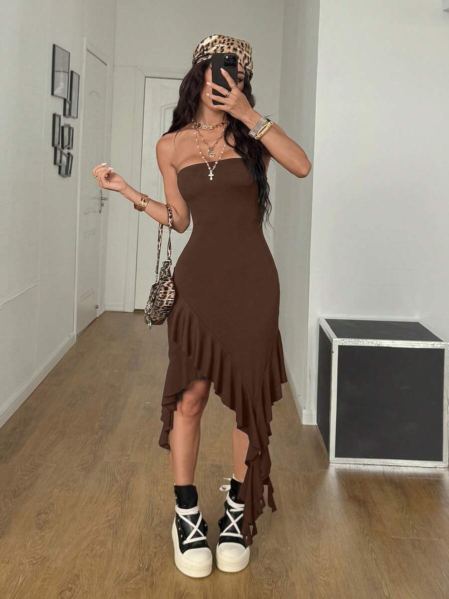 Women's strapless black bandeau midi dress featuring an asymmetrical ruffle hem and a slim fit bodycon silhouette.