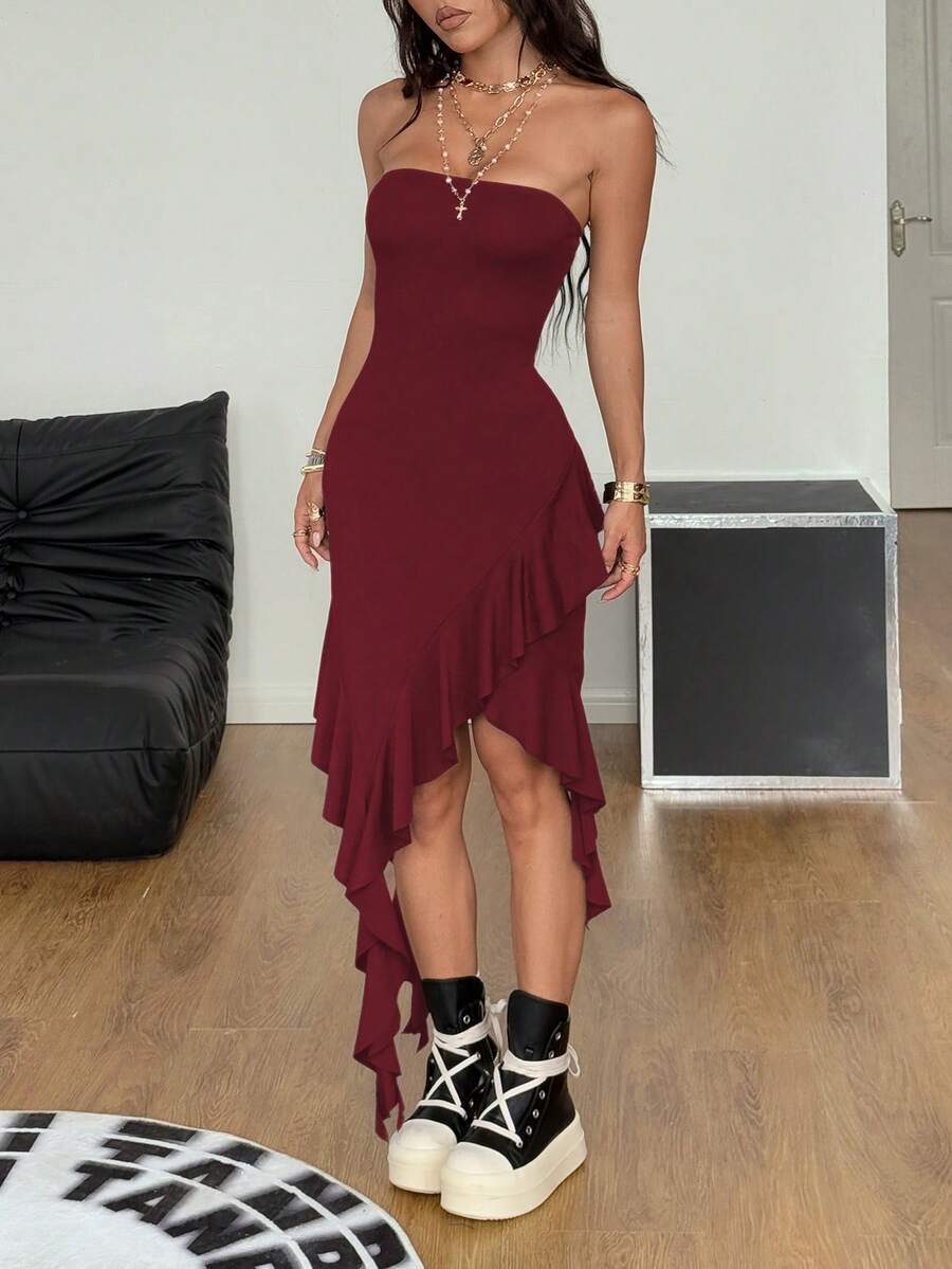 Women's strapless black bandeau midi dress featuring an asymmetrical ruffle hem and a slim fit bodycon silhouette.