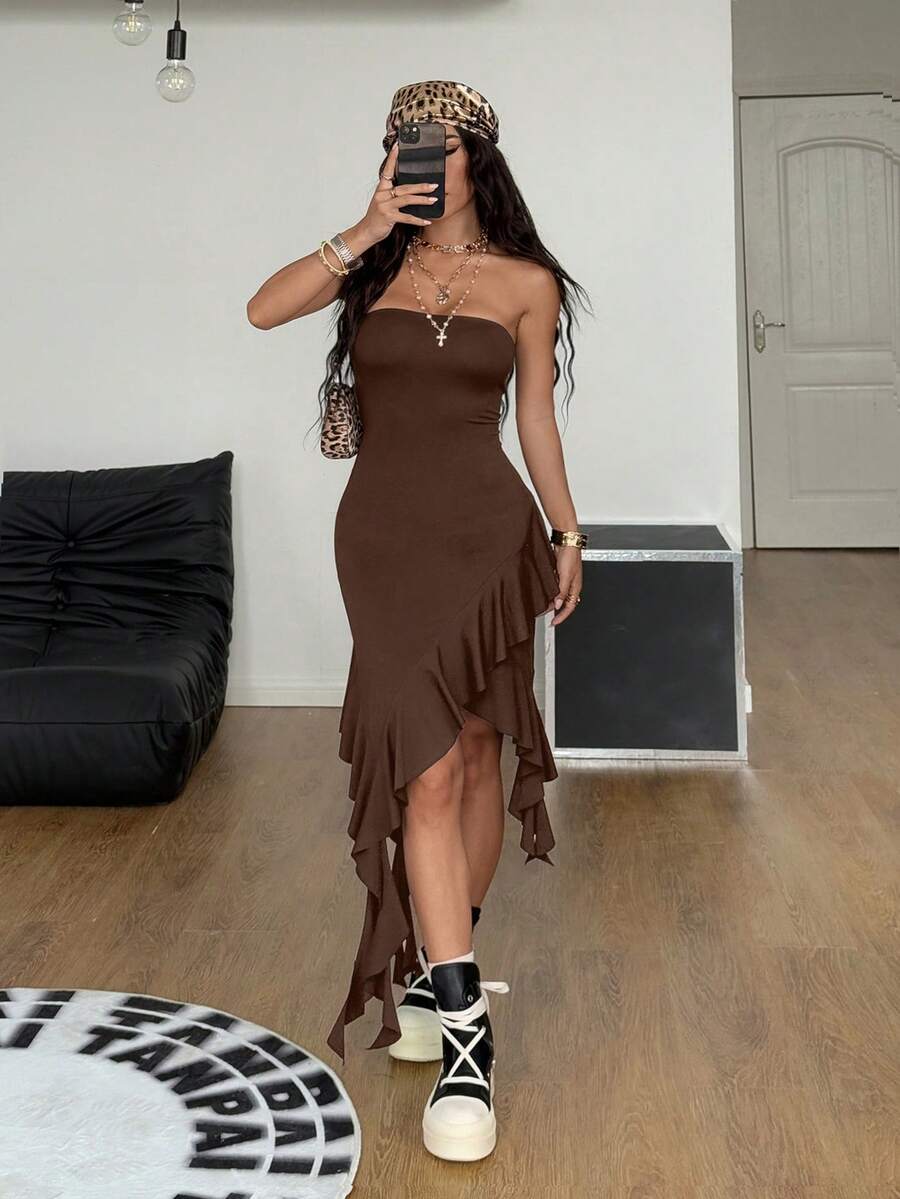 Women's strapless black bandeau midi dress featuring an asymmetrical ruffle hem and a slim fit bodycon silhouette.
