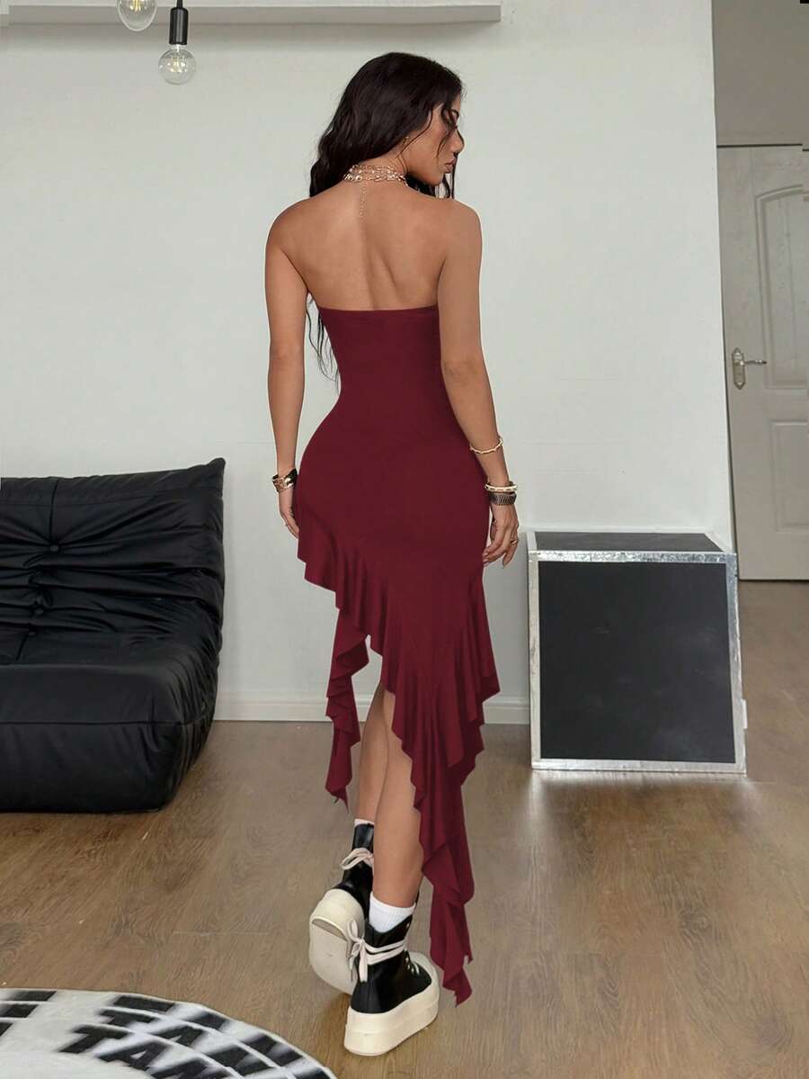 Women's strapless black bandeau midi dress featuring an asymmetrical ruffle hem and a slim fit bodycon silhouette.