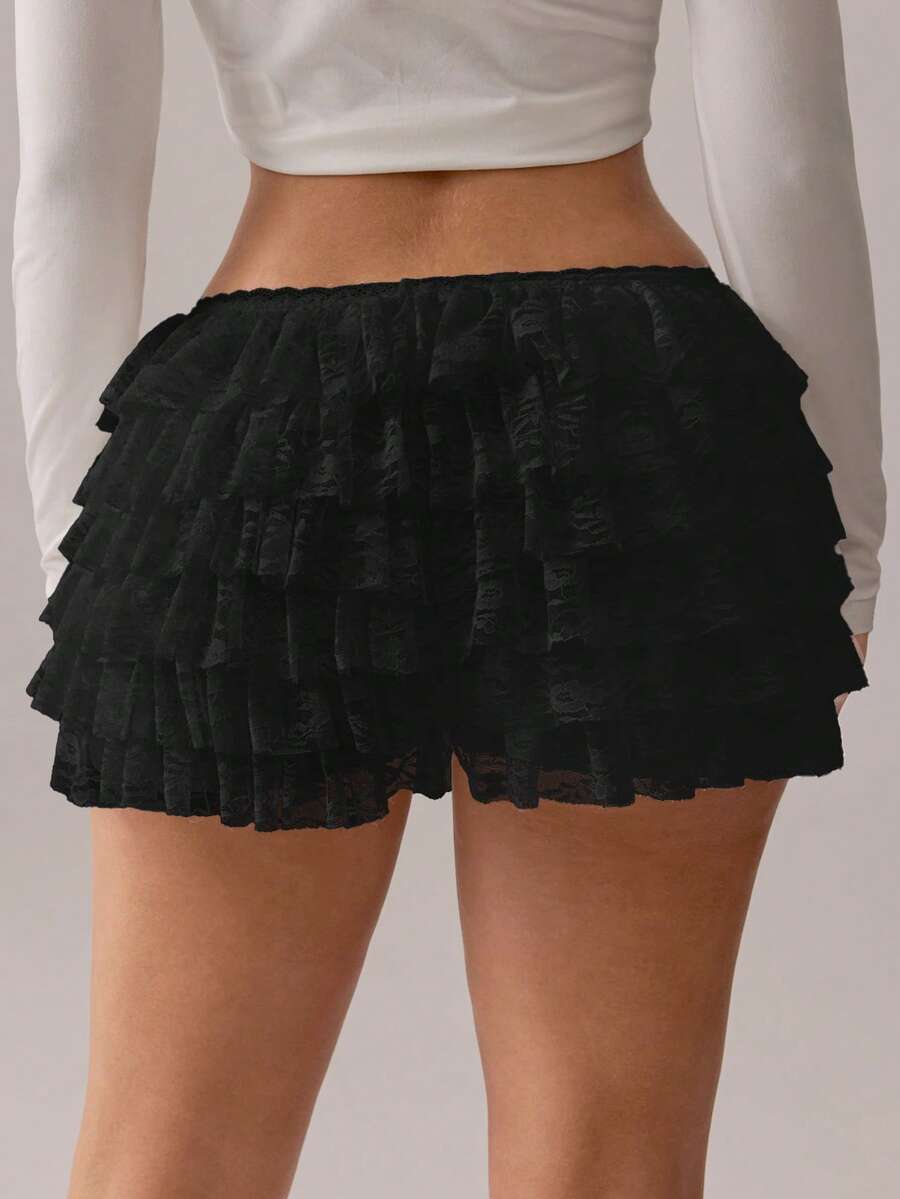 Apricot tiered lace ruffle hem low waist shorts for women featuring elastic waist and lined semi-sheer knit fabric.