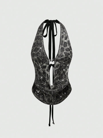 Women's leopard print sequin halter crop top featuring a backless asymmetrical hem design with ring accent.