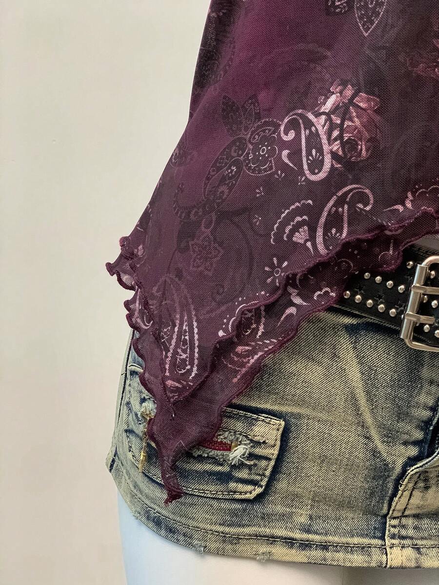 Women's backless halter cami top featuring a paisley print, sleeveless design, and an asymmetrical hem in knitted fabric.