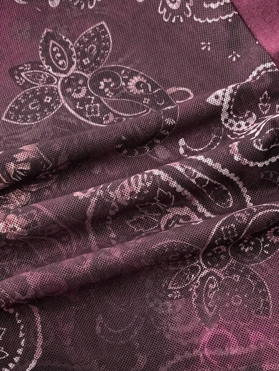 Women's backless halter cami top featuring a paisley print, sleeveless design, and an asymmetrical hem in knitted fabric.