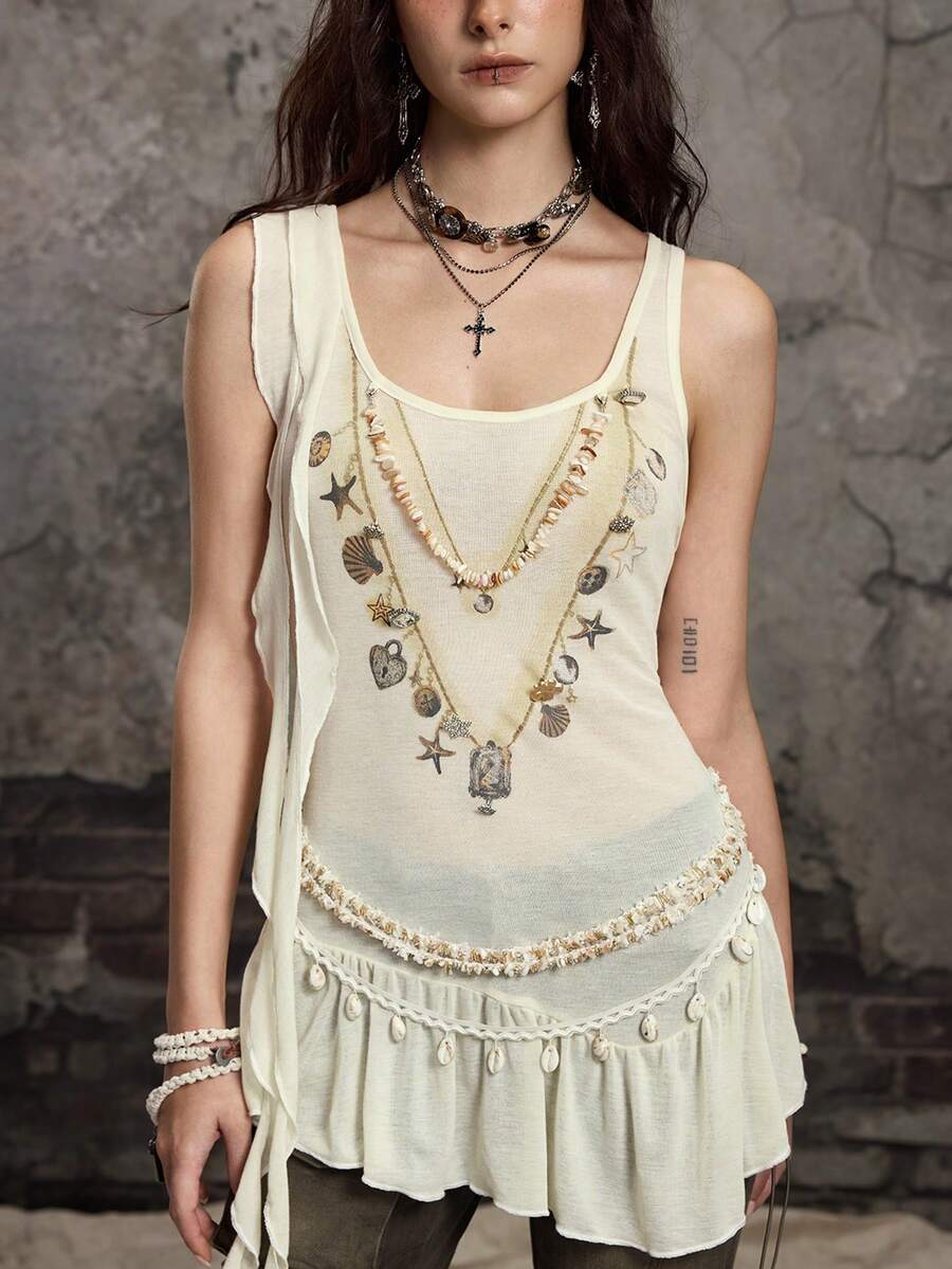 Beige asymmetric cami top for women featuring beaded details, fringe trim, knot accents, and round neck in high stretch knitted fabric.