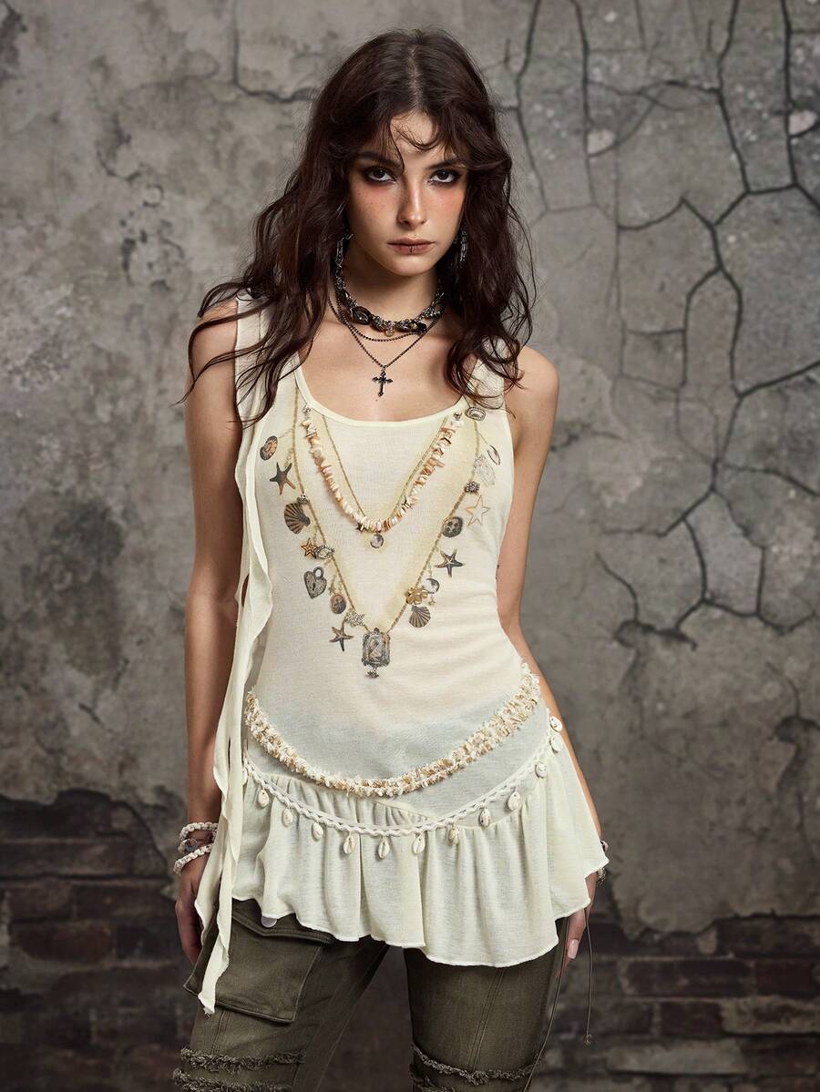 Beige asymmetric cami top for women featuring beaded details, fringe trim, knot accents, and round neck in high stretch knitted fabric.