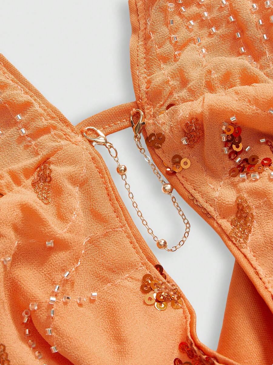Pink sequin halter tank top for women featuring embroidered draped backless design and asymmetrical hem.