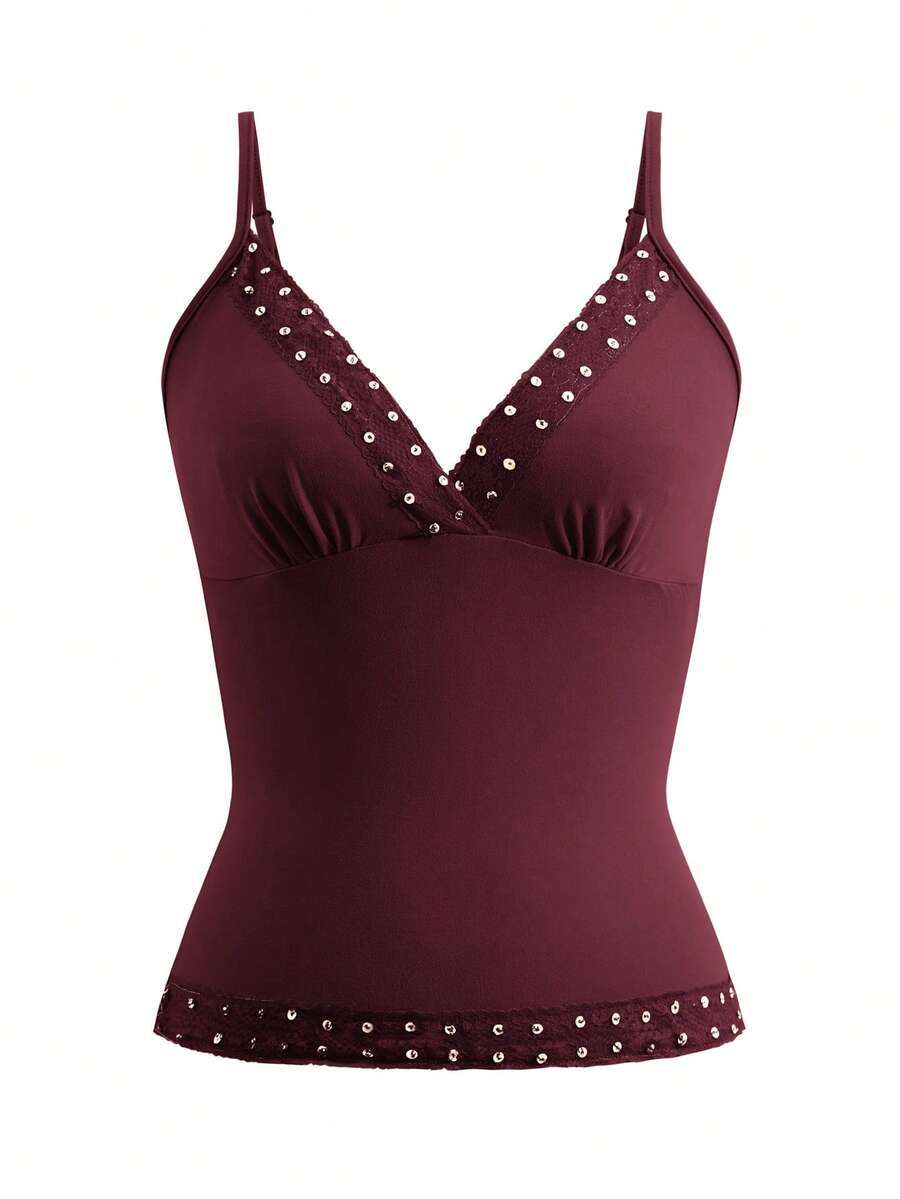 Women's deep V-neck camisole top featuring contrast hollow lace trim, cutout detail, and thin spaghetti straps.