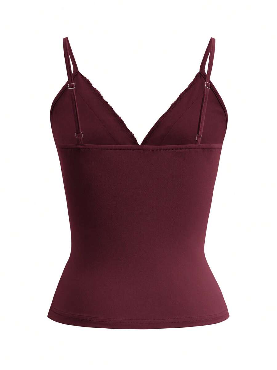 Women's deep V-neck camisole top featuring contrast hollow lace trim, cutout detail, and thin spaghetti straps.