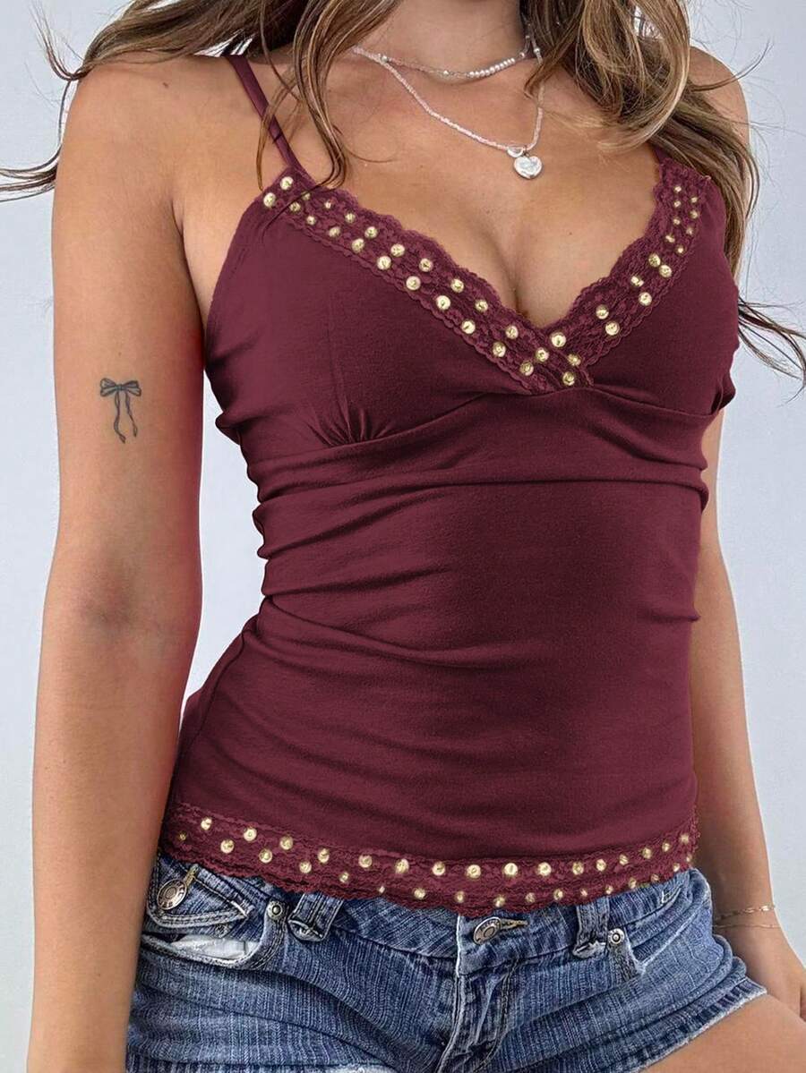 Women's deep V-neck camisole top featuring contrast hollow lace trim, cutout detail, and thin spaghetti straps.