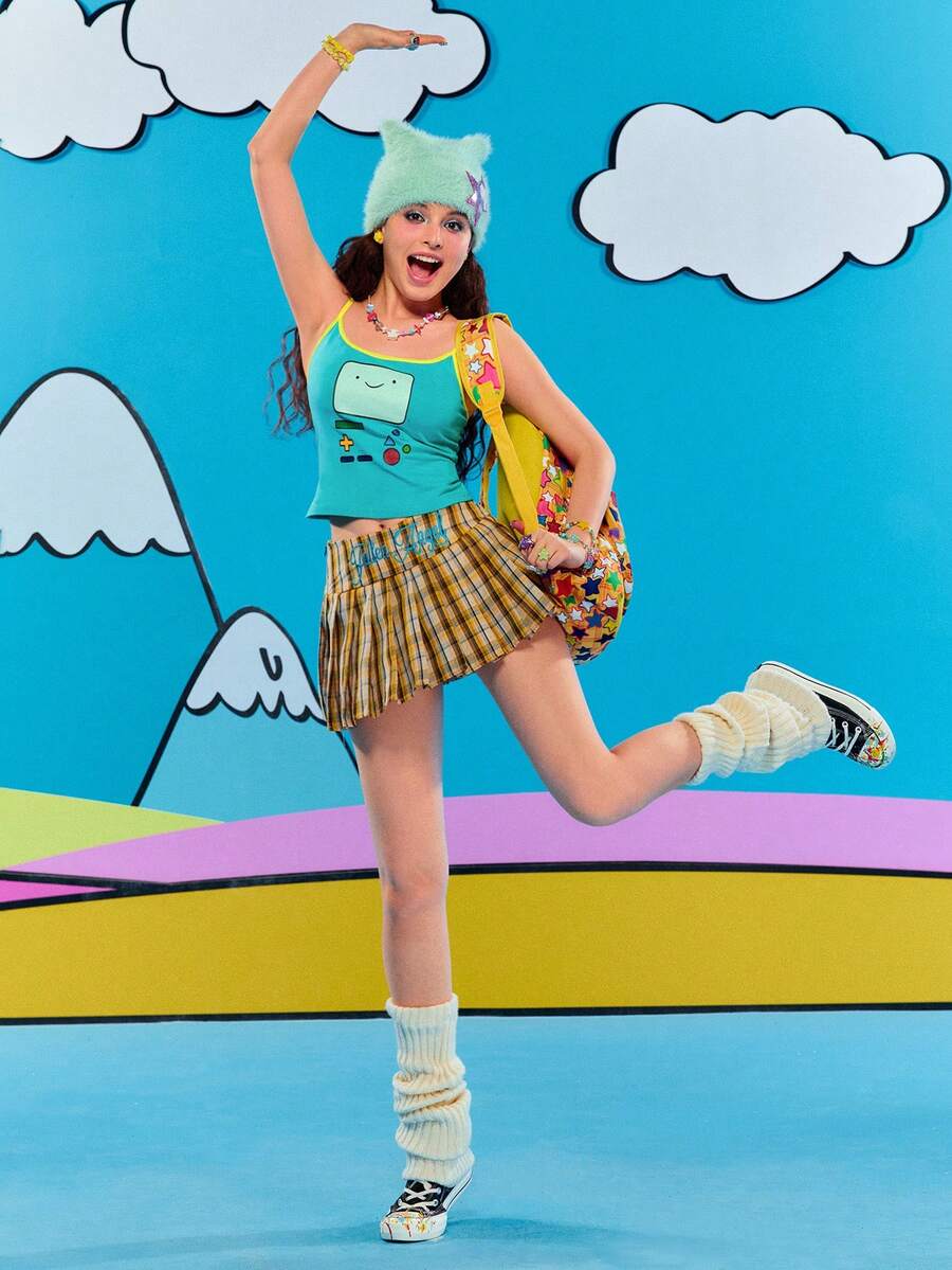 Teal blue slim fit crop camisole top for women featuring a graphic cartoon face print, contrast color trim, and thin spaghetti straps.
