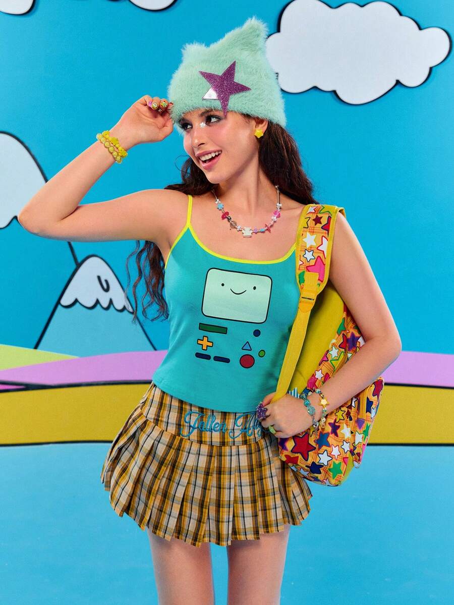 Teal blue slim fit crop camisole top for women featuring a graphic cartoon face print, contrast color trim, and thin spaghetti straps.
