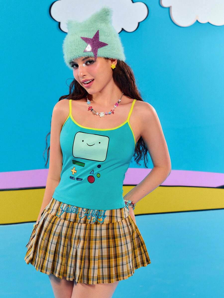 Teal blue slim fit crop camisole top for women featuring a graphic cartoon face print, contrast color trim, and thin spaghetti straps.