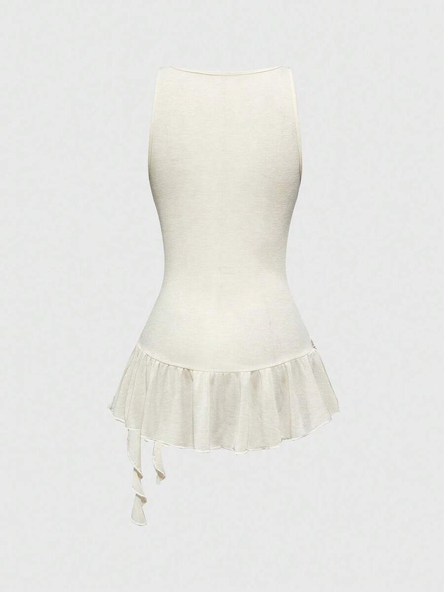 Beige asymmetric cami top for women featuring beaded details, fringe trim, knot accents, and round neck in high stretch knitted fabric.