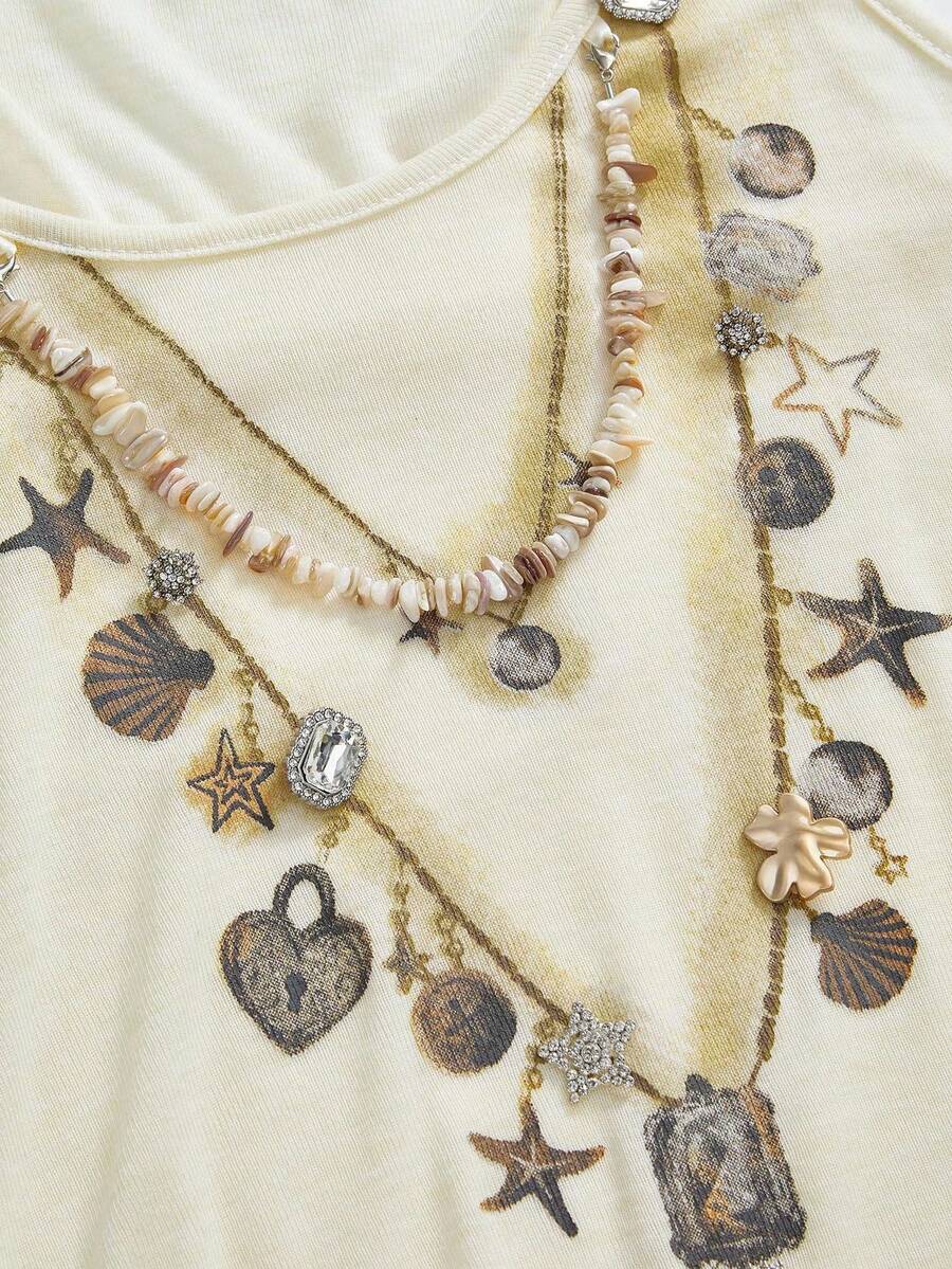 Beige asymmetric cami top for women featuring beaded details, fringe trim, knot accents, and round neck in high stretch knitted fabric.