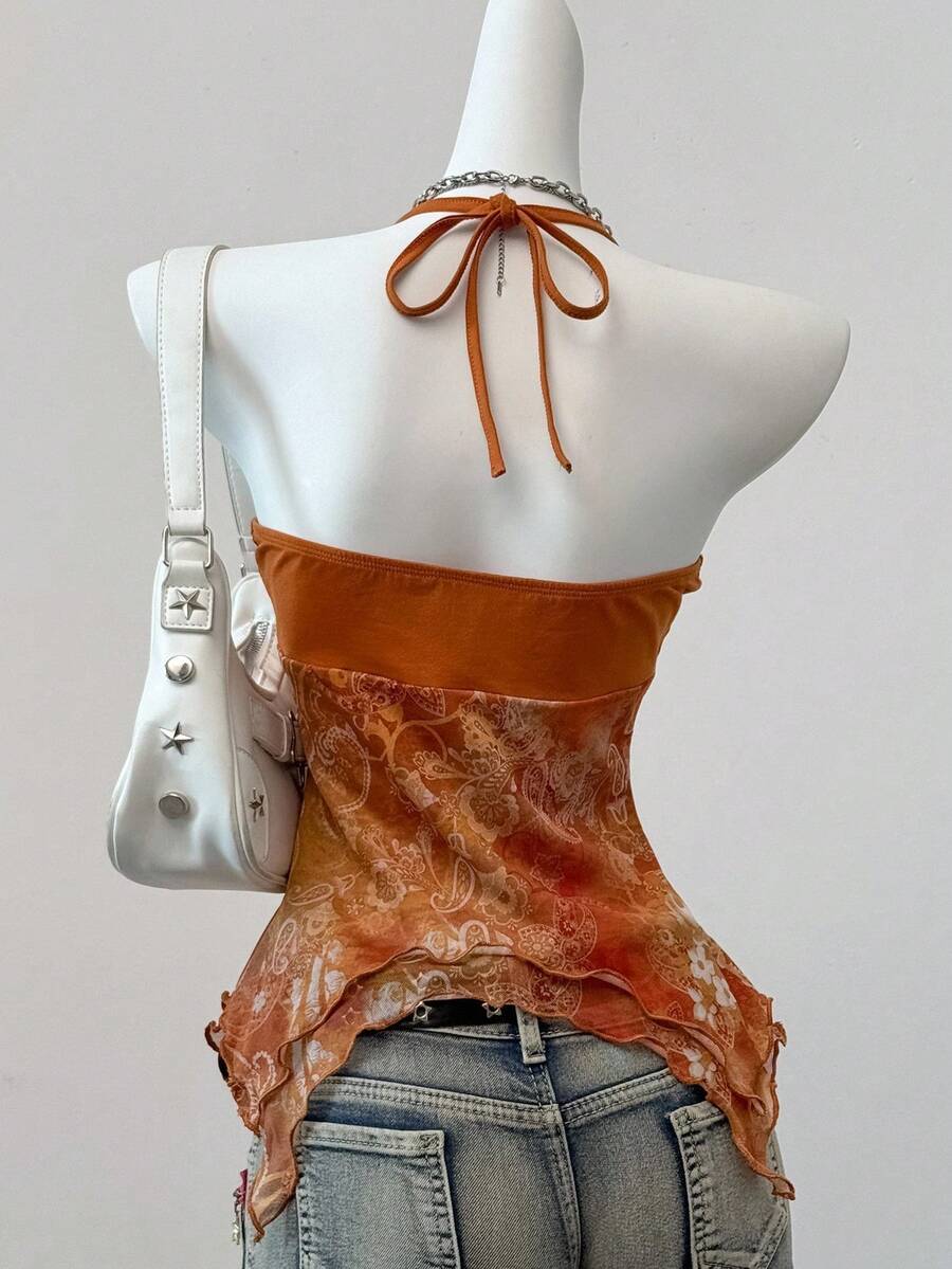 Women's backless halter cami top featuring a paisley print, sleeveless design, and an asymmetrical hem in knitted fabric.