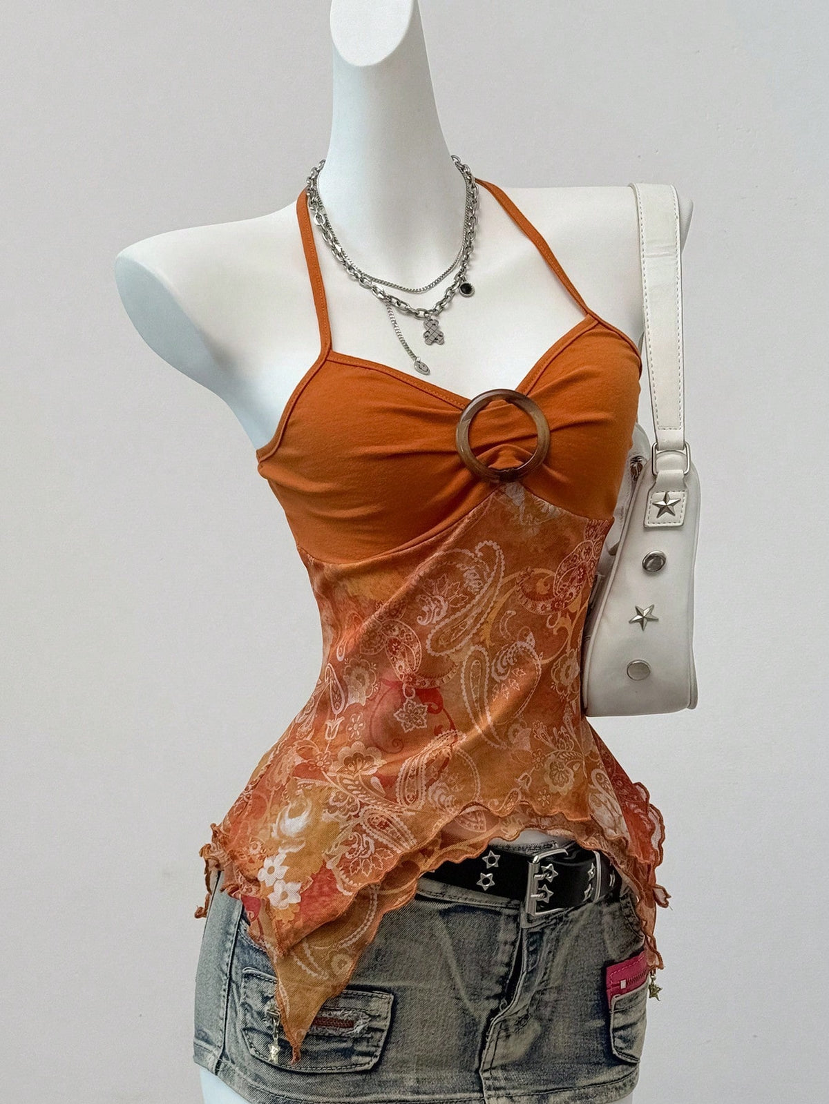 Women's backless halter cami top featuring a paisley print, sleeveless design, and an asymmetrical hem in knitted fabric.
