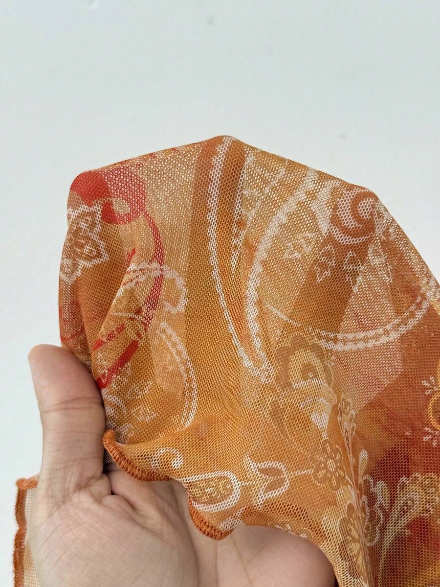 Women's backless halter cami top featuring a paisley print, sleeveless design, and an asymmetrical hem in knitted fabric.