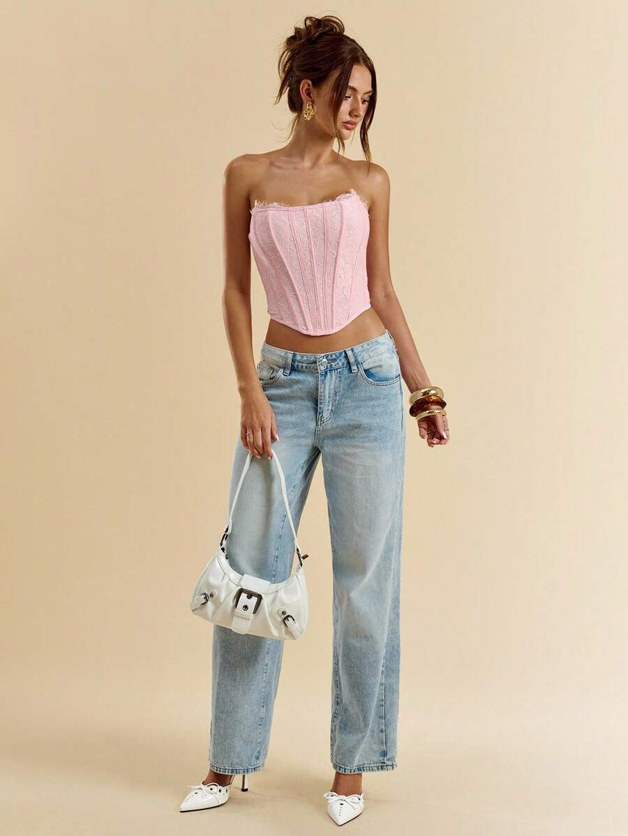 Women's strapless bustier crop top with contrast lace, lace-up detail, and an asymmetric hem in a slim-fit satin finish.