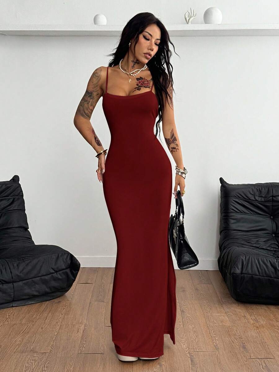 Women's Y2K backless spaghetti strap maxi dress featuring a lace-up back and high split thigh in black knitted fabric.