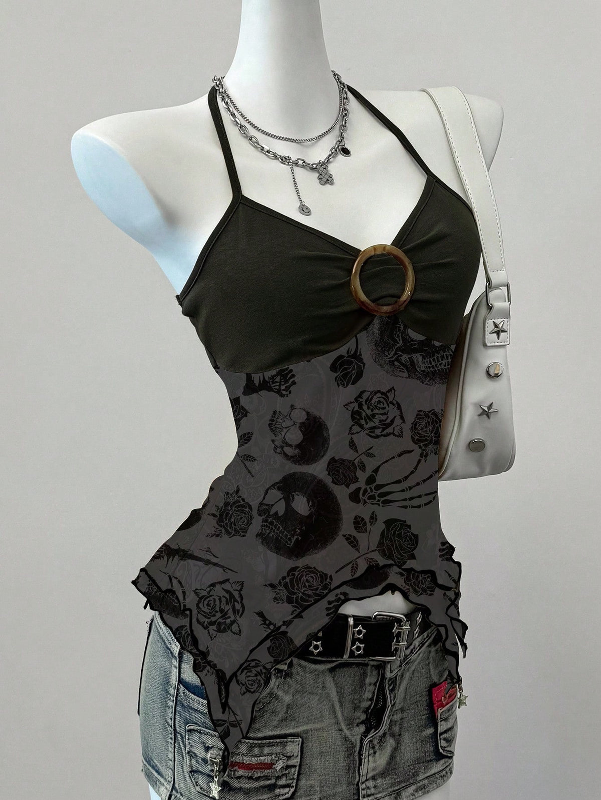Women's backless halter cami top featuring a paisley print, sleeveless design, and an asymmetrical hem in knitted fabric.