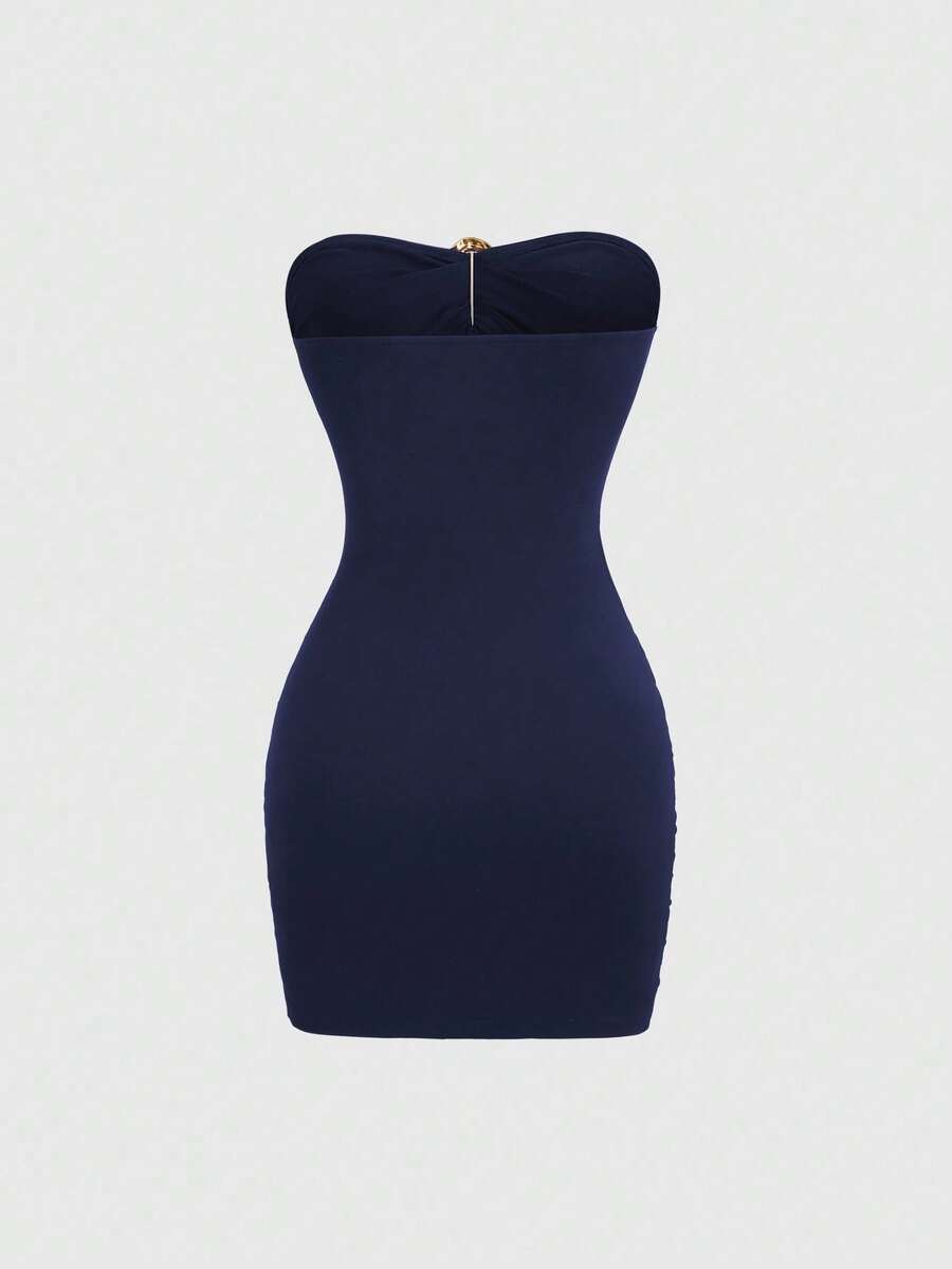 Women's black strapless bodycon mini dress featuring ruched detailing, cut-out design with ring accent, mid-waist pencil hem, and slim fit knitted stretch fabric.