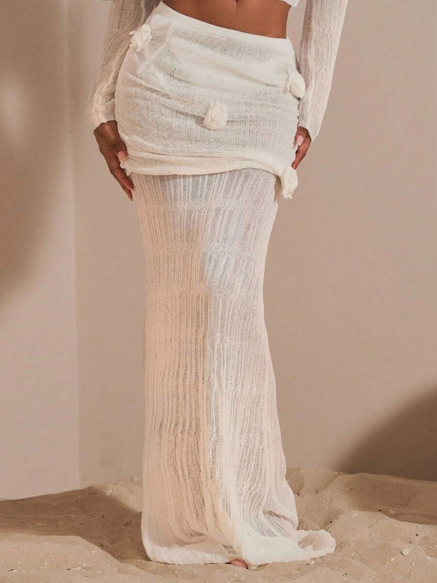 Beige women's knit maxi skirt featuring a pleated 3D floral pattern, low waist, skinny fit, and fishtail hem.