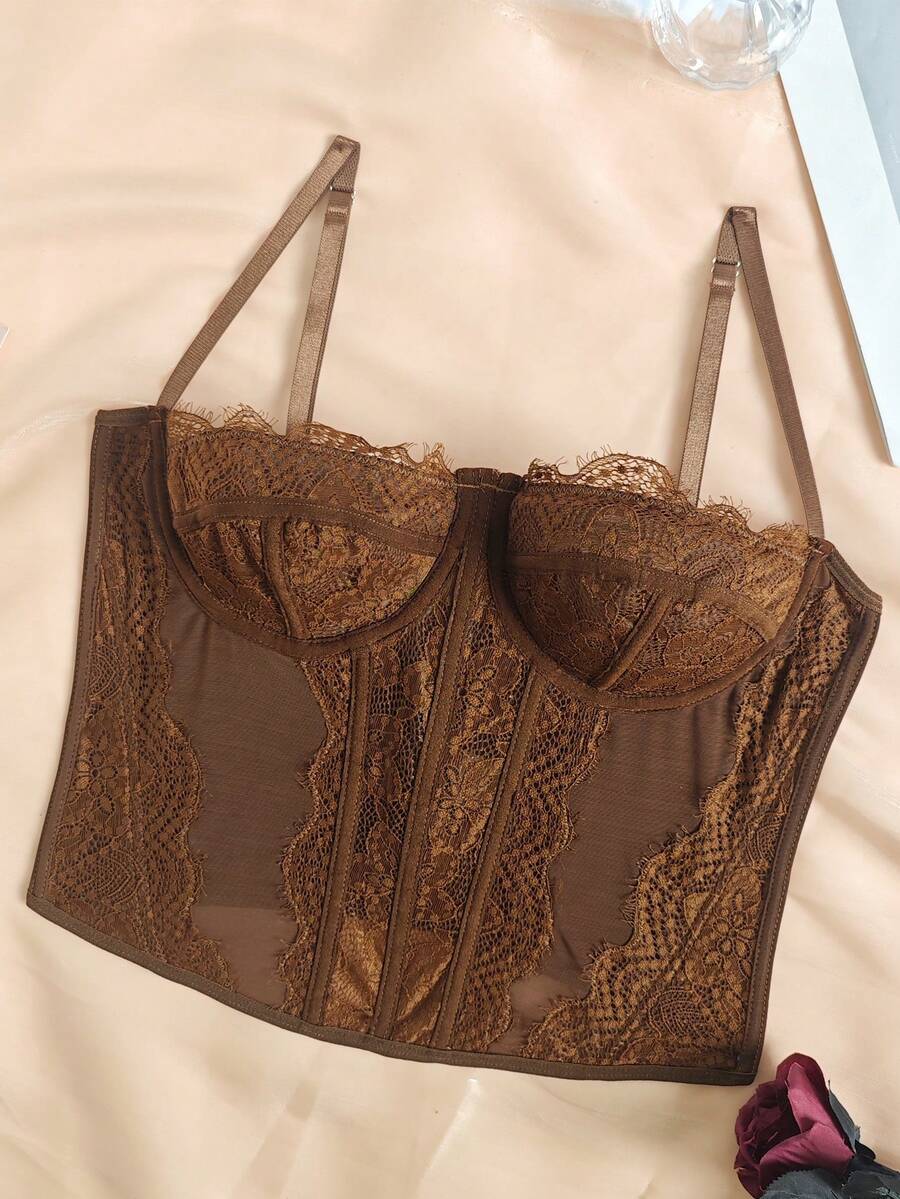 Women's brown lace trim cami corset crop top featuring a low cut neck, unlined body, and slim fit bodycon silhouette.
